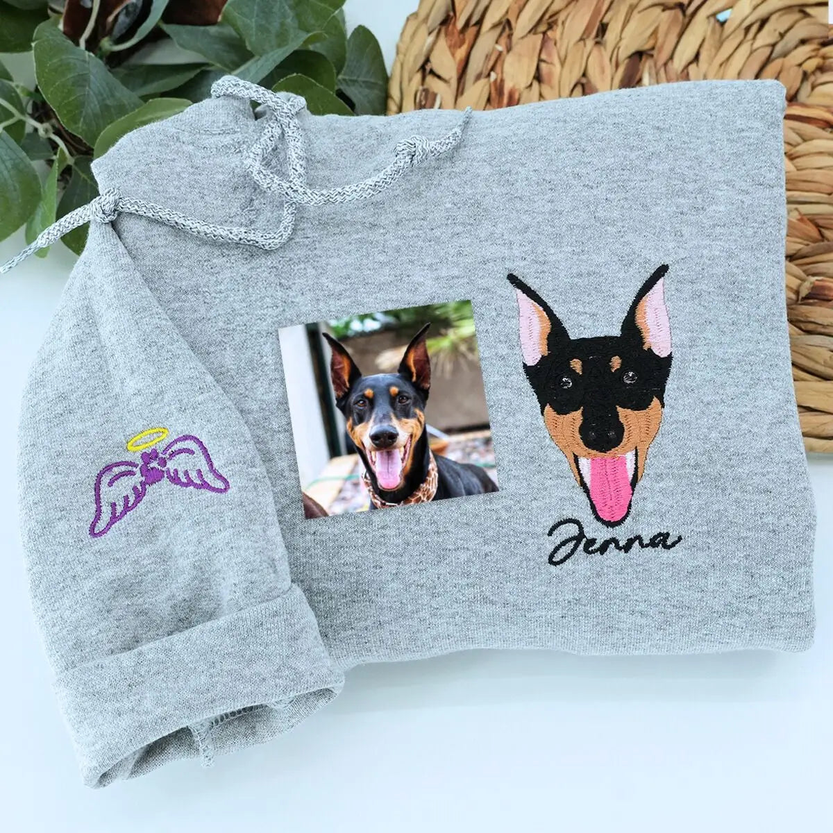 Custom embroidered sweatshirt featuring a realistic portrait of a Doberman dog with name on the sleeve
