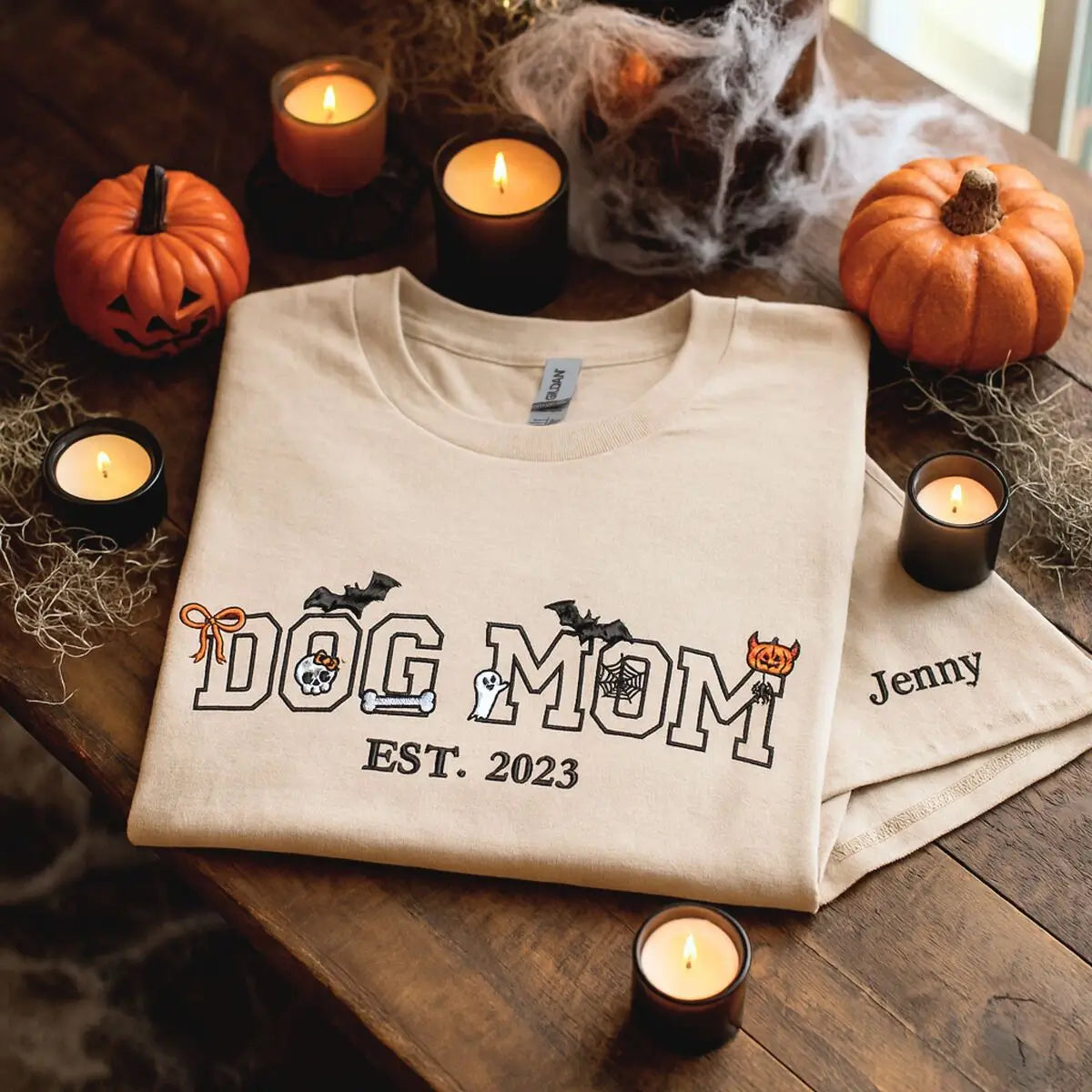 Custom embroidered Halloween shirt for dog moms with cute pumpkin, ghost, and bones design around “Dog Mom” text