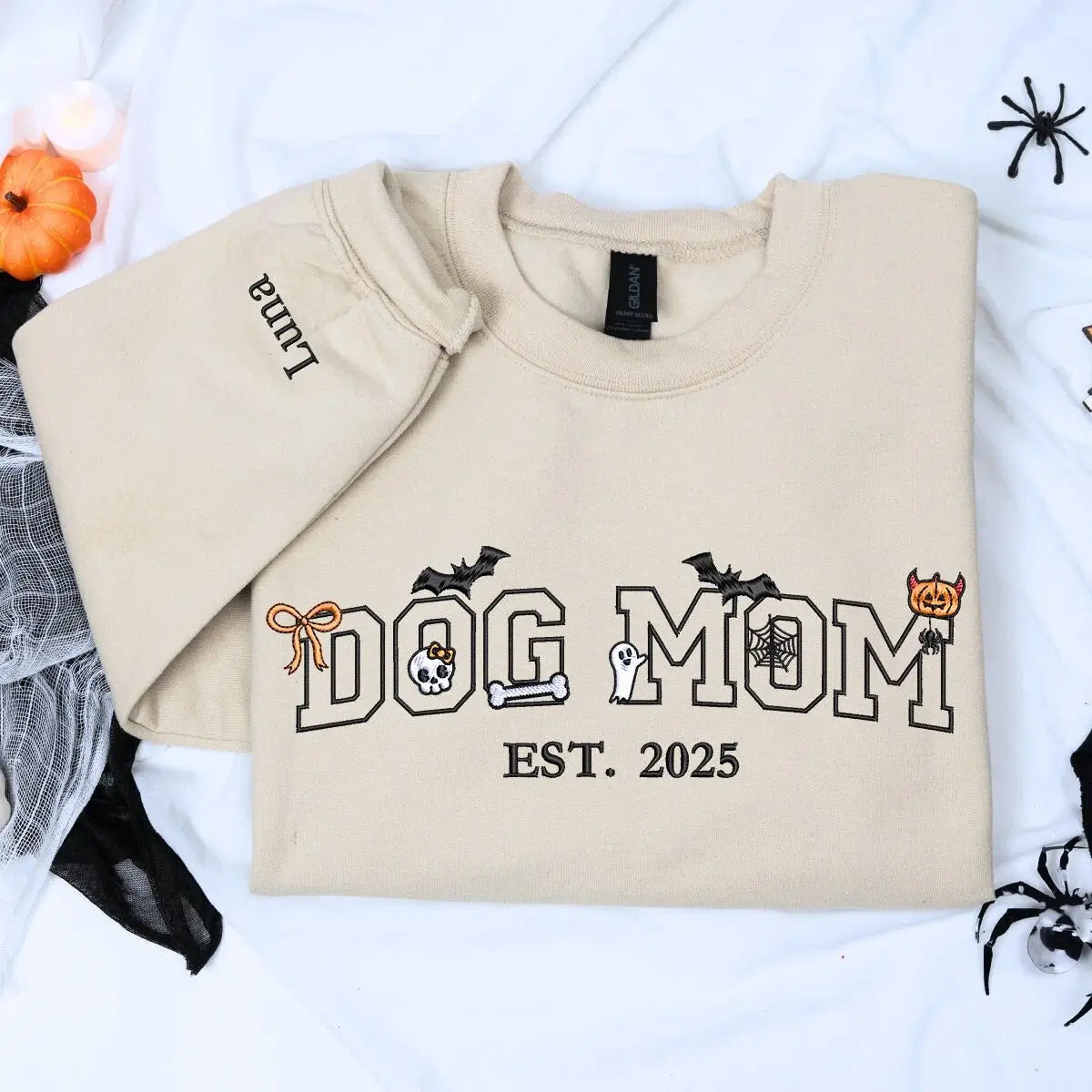 Custom embroidered Halloween sweatshirt for dog moms with cute pumpkin, ghost, and bones design around “Dog Mom” text