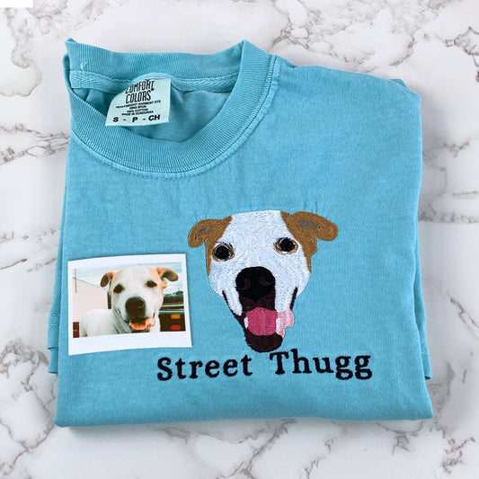 Teal Comfort Colors tee with colorful embroidered dog face and custom pet name stitched below