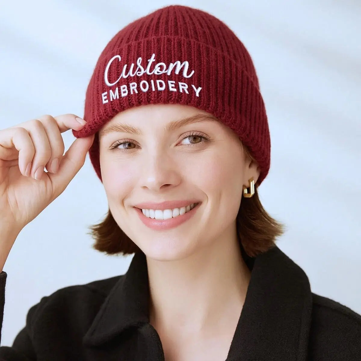 Custom embroidered beanie with personalized text logo, warm winter knit hat for women or branding use.
