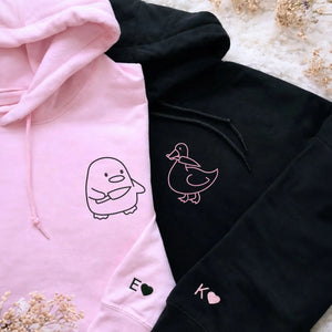 Custom embroidered Duck Duck Goose couple hoodie worn by boyfriend and girlfriend as a personalized Valentine’s gift
