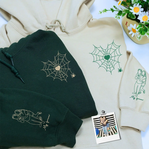 Custom embroidered couple hoodie with spider web design and personalized portrait on sleeve