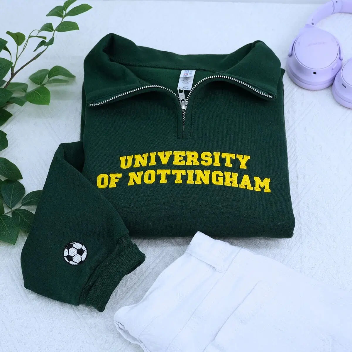 custom embroidered quarter zip sweatshirt with university logo on chest