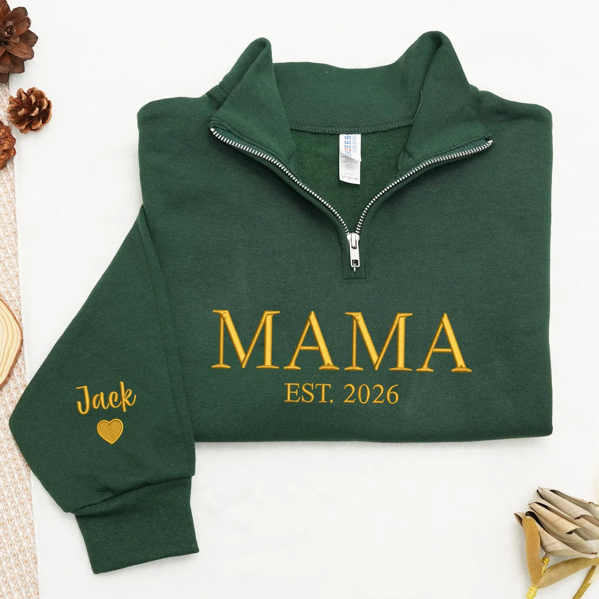Green sweatshirt with 'MAMA EST. 2026' text on sleeve
