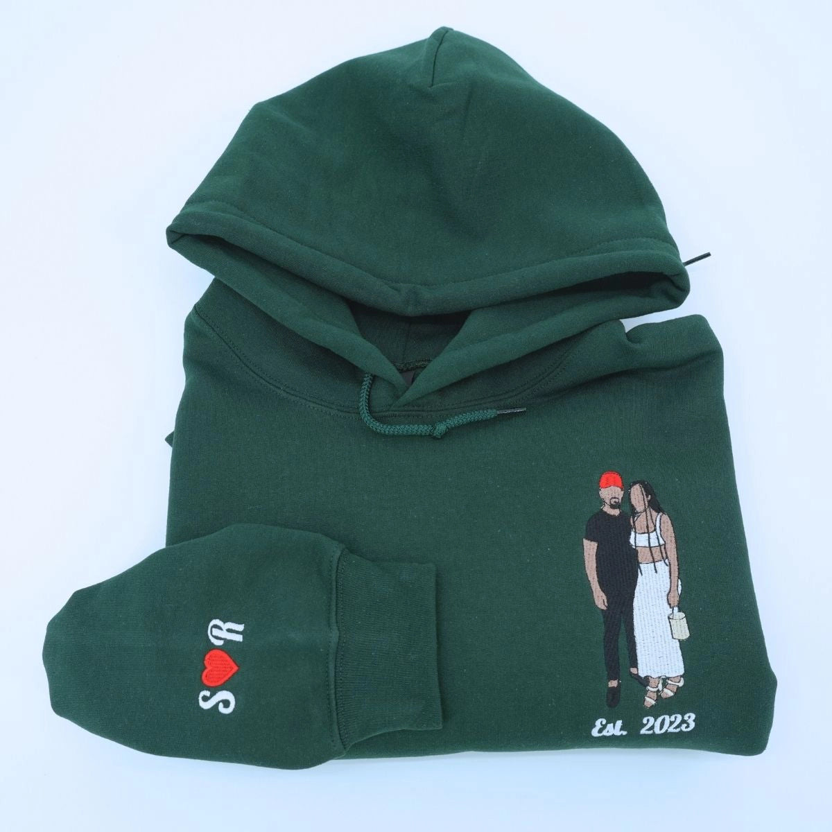 Custom embroidered portrait hoodie featuring personalized couple photo in high-quality threads on forest green cotton hoodie.