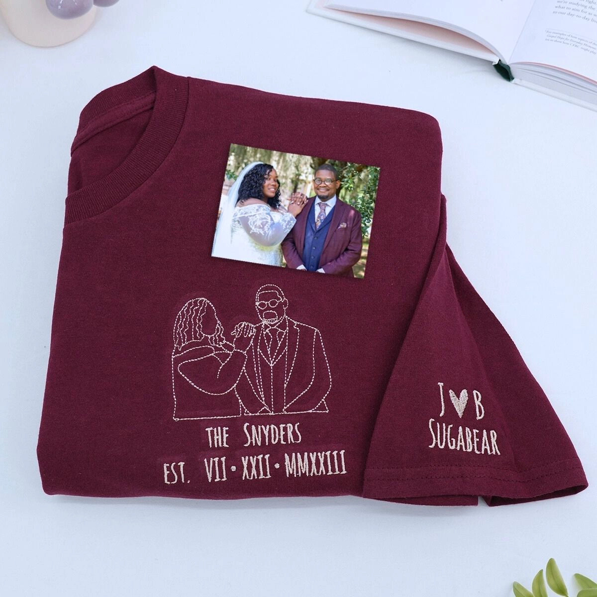 Custom embroidered portrait t-shirt featuring personalized couple photo in high-quality threads on maroon cotton shirt.