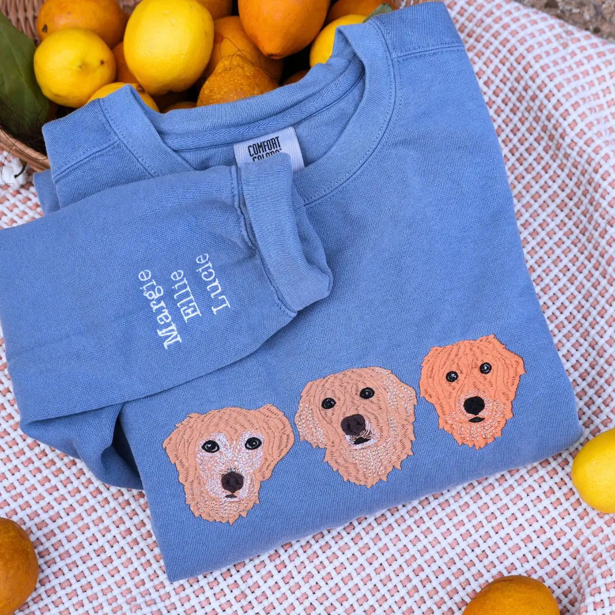 Custom embroidered sweatshirt with golden retriever portrait and personalized sleeve name