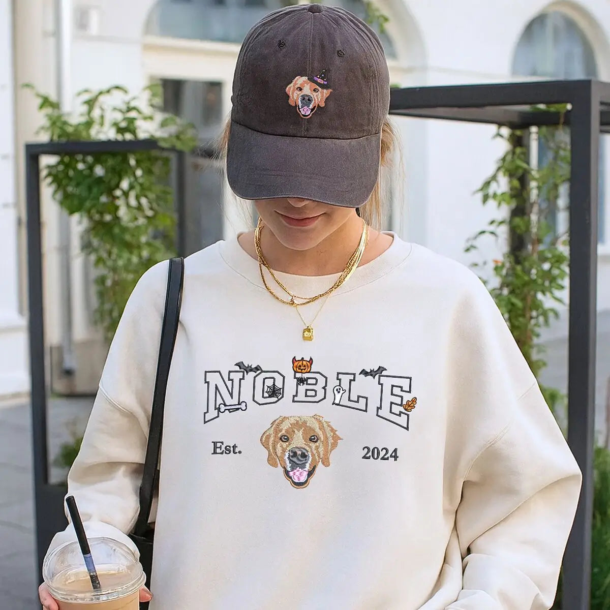 mbroidered custom Halloween sweatshirt with dog face, name, and spooky icons like bats and pumpkins