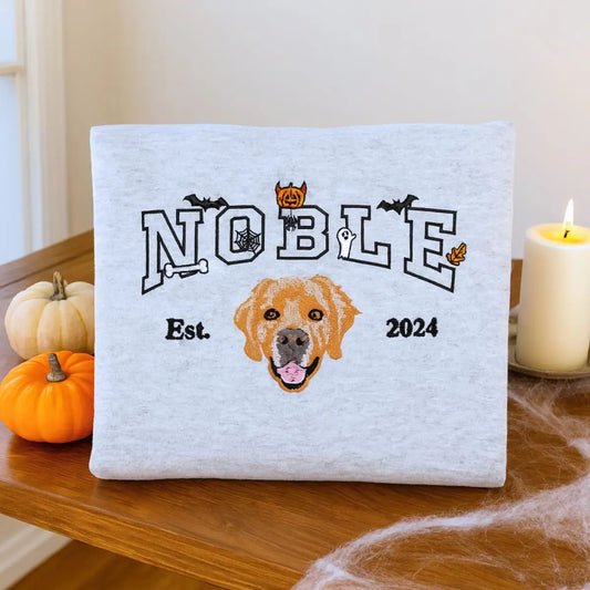 mbroidered custom Halloween sweatshirt with dog face, name, and spooky icons like bats and pumpkins