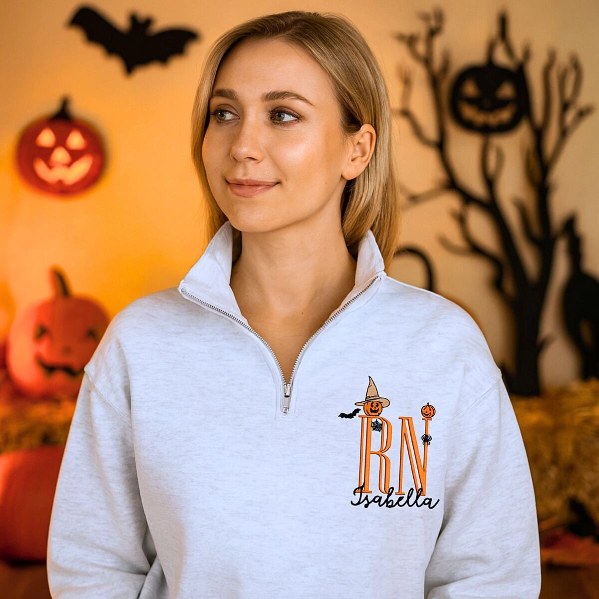Custom embroidered Halloween nurse sweatshirt with name and cute icon, cozy quarter-zip design for medical professionals