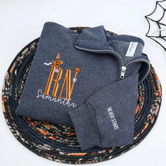 Custom embroidered Halloween nurse sweatshirt with name and cute icon, cozy quarter-zip design for medical professionals