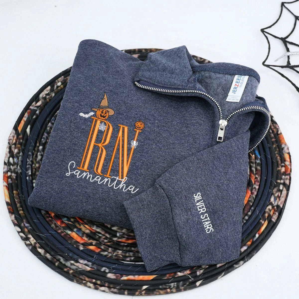 Custom embroidered Halloween nurse sweatshirt with name and cute icon, cozy quarter-zip design for medical professionals