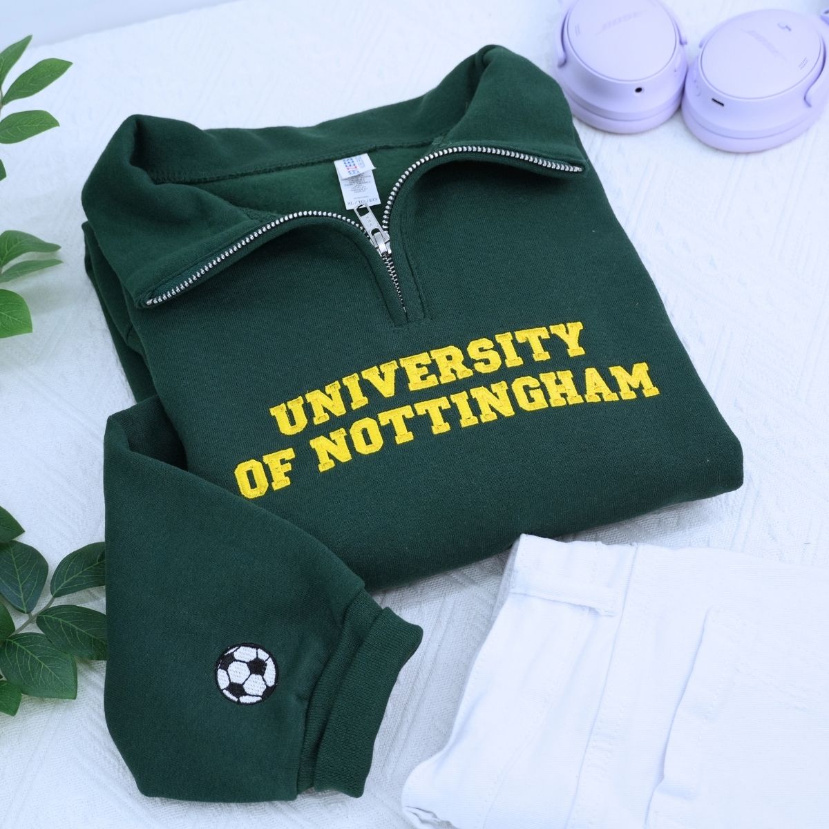 Custom embroidered quarter zip sweatshirt with company logo and text on sleeve, ideal for corporate team apparel.