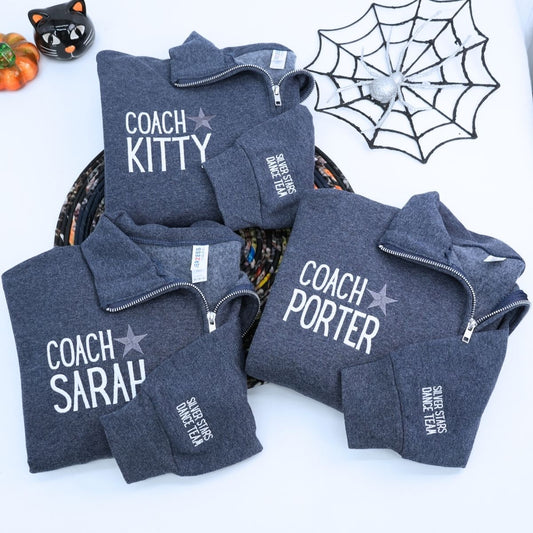 Custom embroidered quarter zip sweatshirt with company logo and text on sleeve, ideal for corporate team apparel.