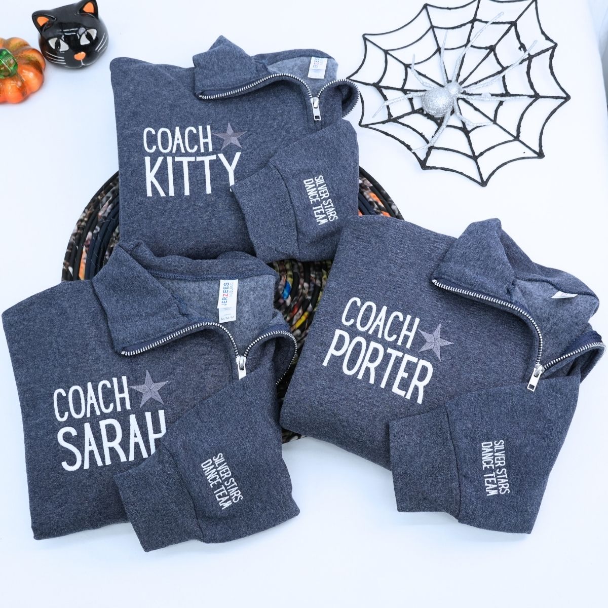 Custom embroidered quarter zip sweatshirt with company logo and text on sleeve, ideal for corporate team apparel.