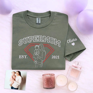 Custom embroidered shirt featuring mother and child portrait stitched from photo