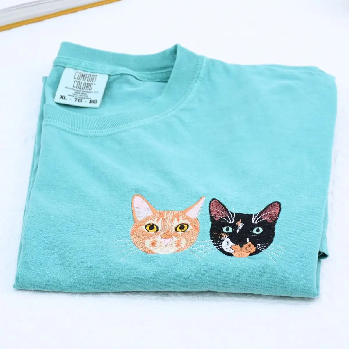 Custom white t-shirt with a embroidered cat dog face portrait, personalized from a customer photo