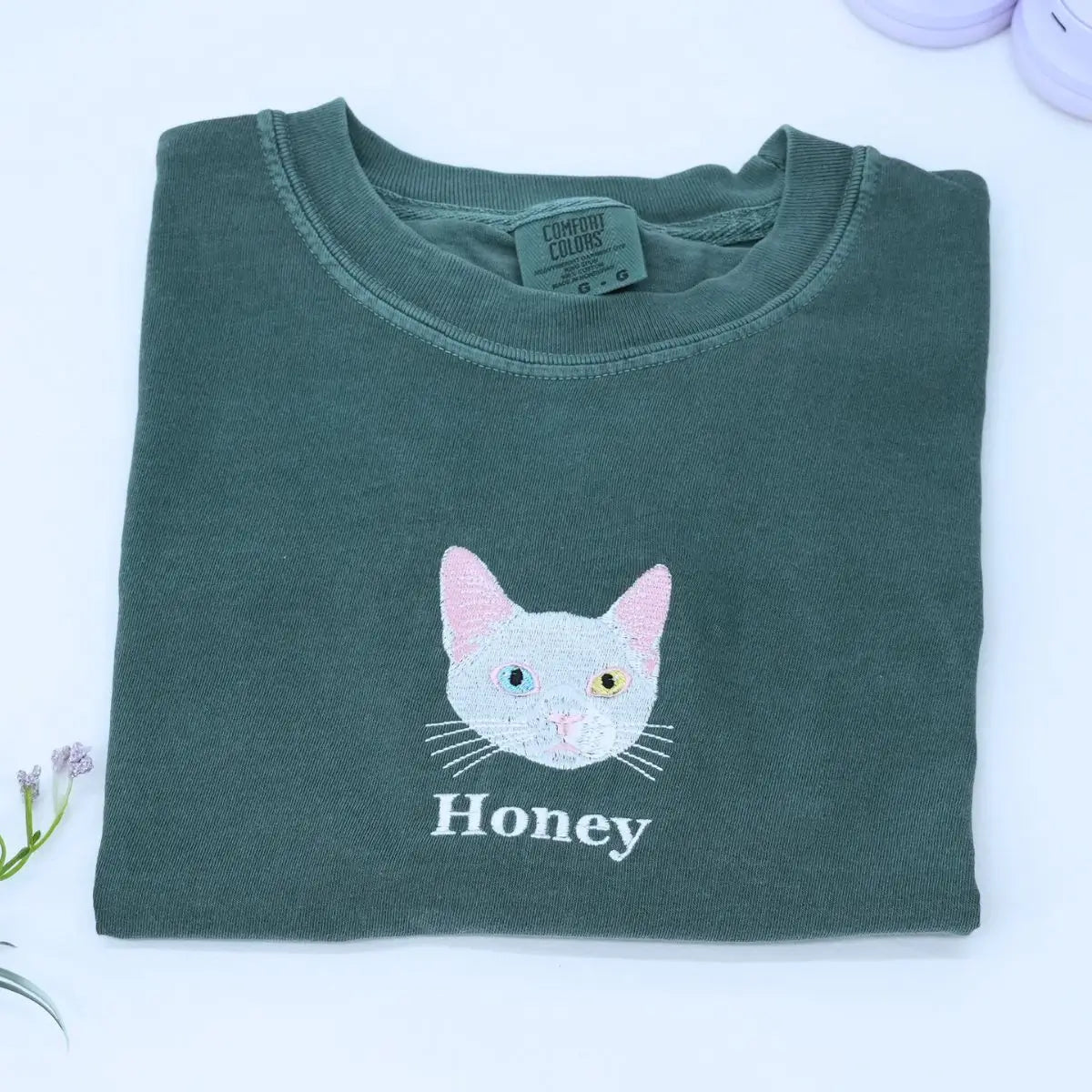 Custom white t-shirt with a embroidered cat dog face portrait, personalized from a customer photo