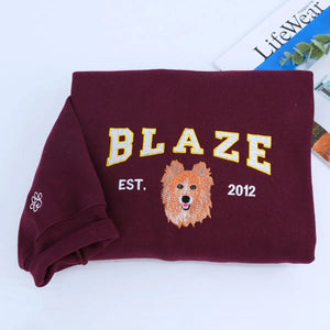 Custom embroidered sweatshirt with realistic Pomeranian dog portrait and name stitched on sleeve