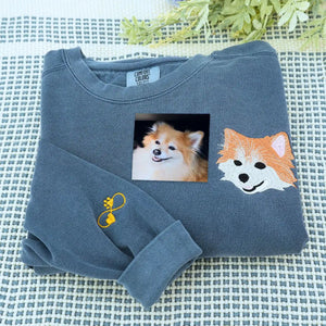 Custom embroidered sweatshirt with realistic Pomeranian dog portrait and name stitched on sleeve