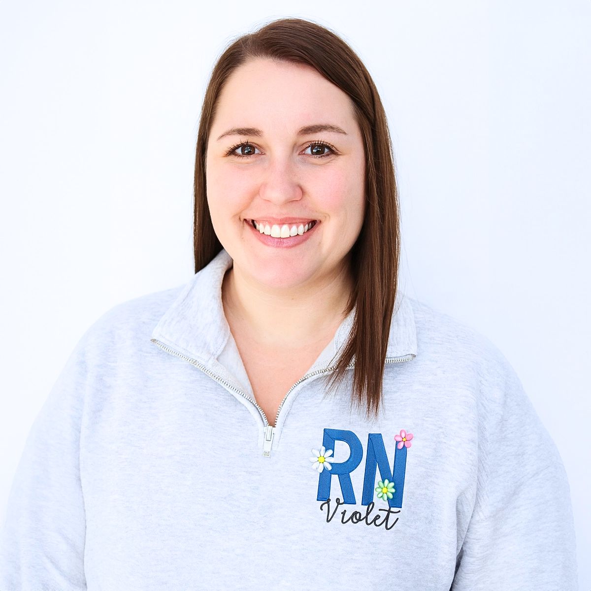 Embroidered RN sweatshirt with floral design and custom name, perfect personalized gift for nurses or nursing students