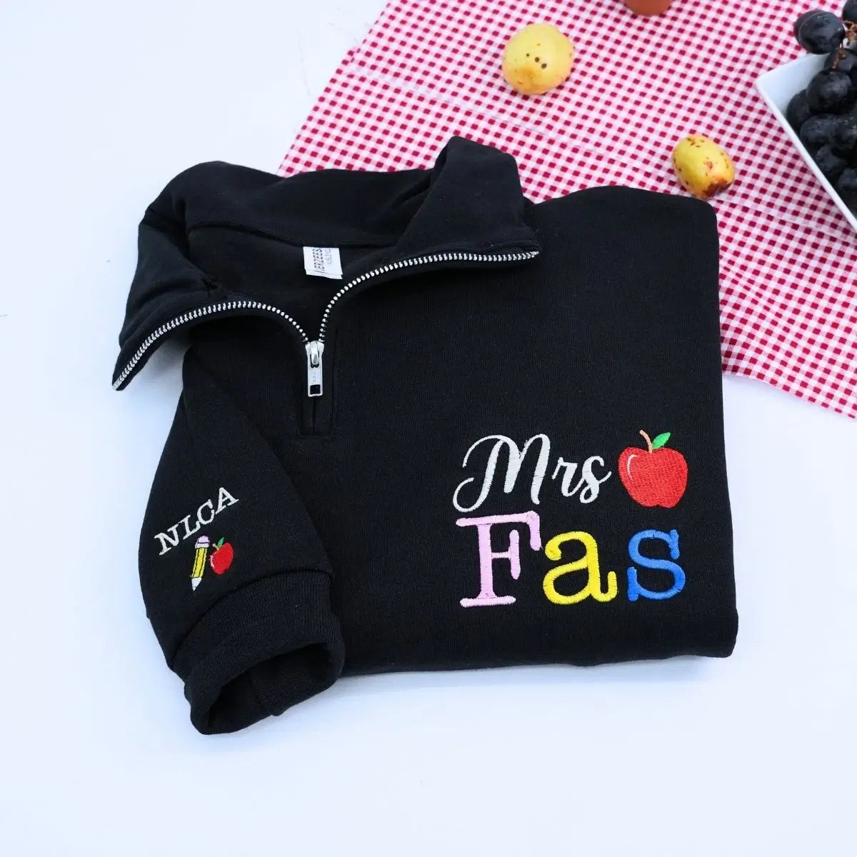 Custom embroidered teacher quarter zip sweatshirt with apple icon and personalized sleeve text