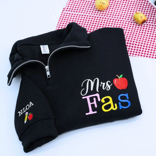 Custom embroidered teacher quarter zip sweatshirt with apple icon and personalized sleeve text