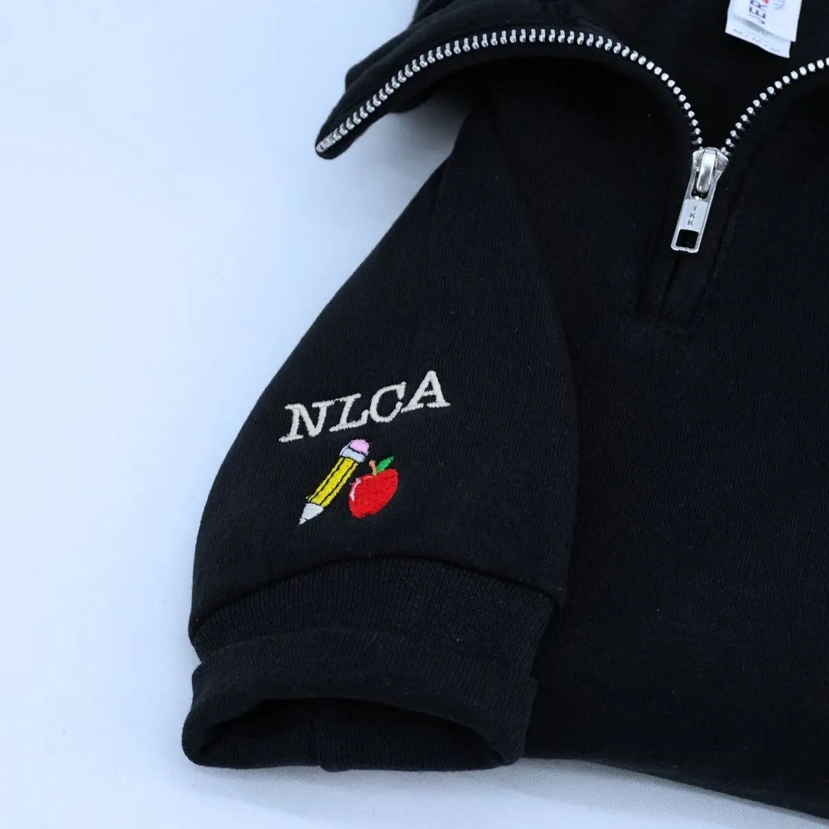 Custom embroidered teacher quarter zip sweatshirt with apple icon and personalized sleeve text
