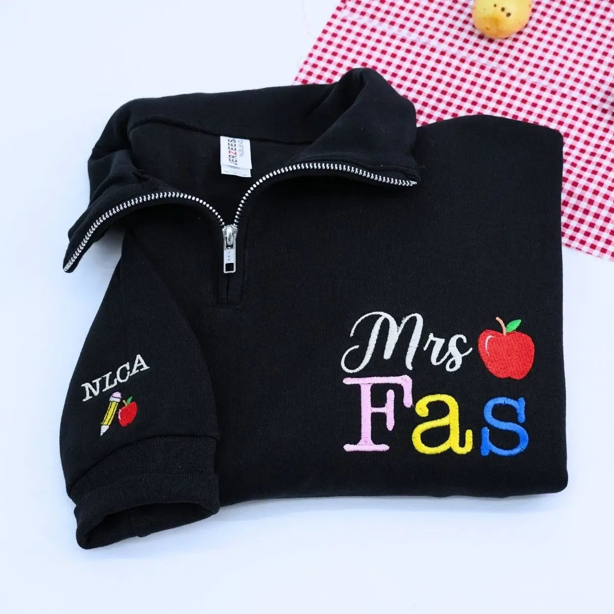 Custom embroidered teacher quarter zip sweatshirt with apple icon and personalized sleeve text