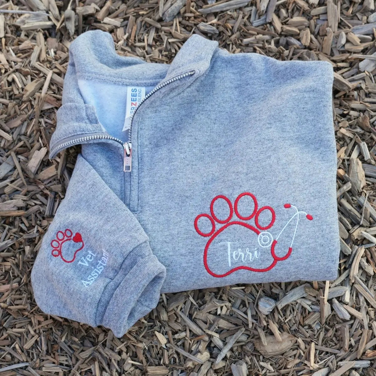 Custom embroidered quarter zip vet tech sweatshirt with personalized name and sleeve text