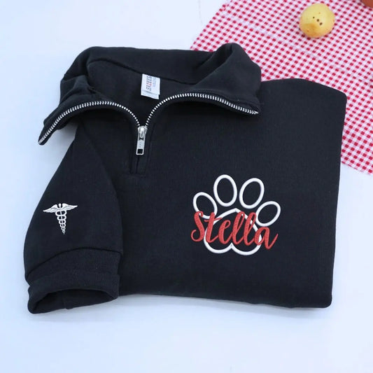 Custom embroidered veterinarian sweatshirt with paw print and name on chest