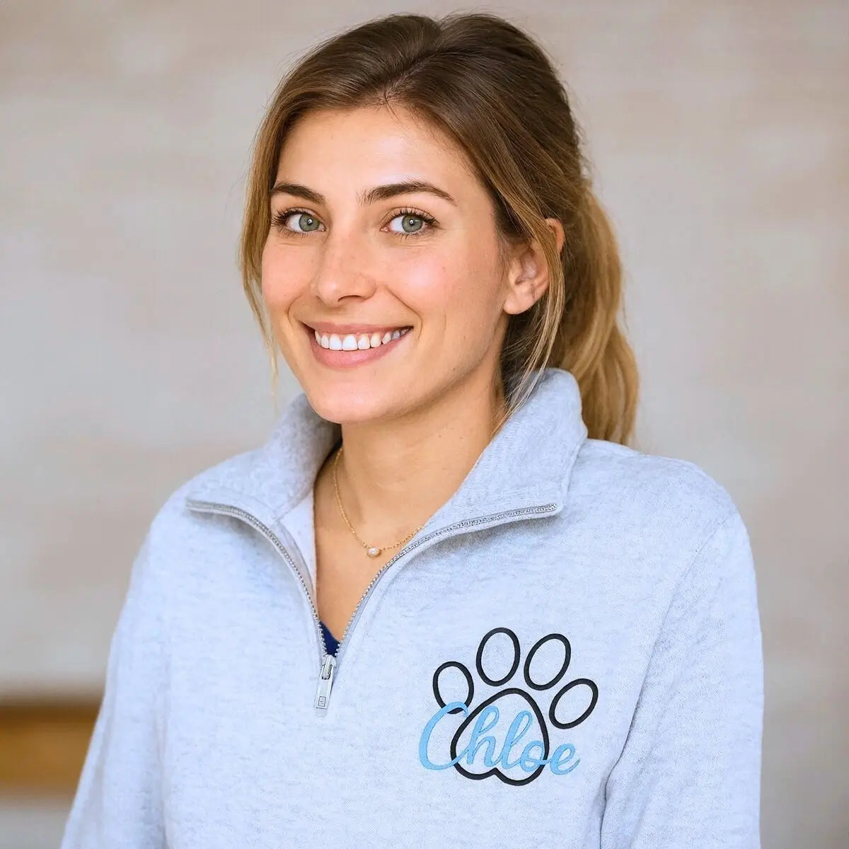 Custom embroidered veterinarian sweatshirt with paw print and name on chest