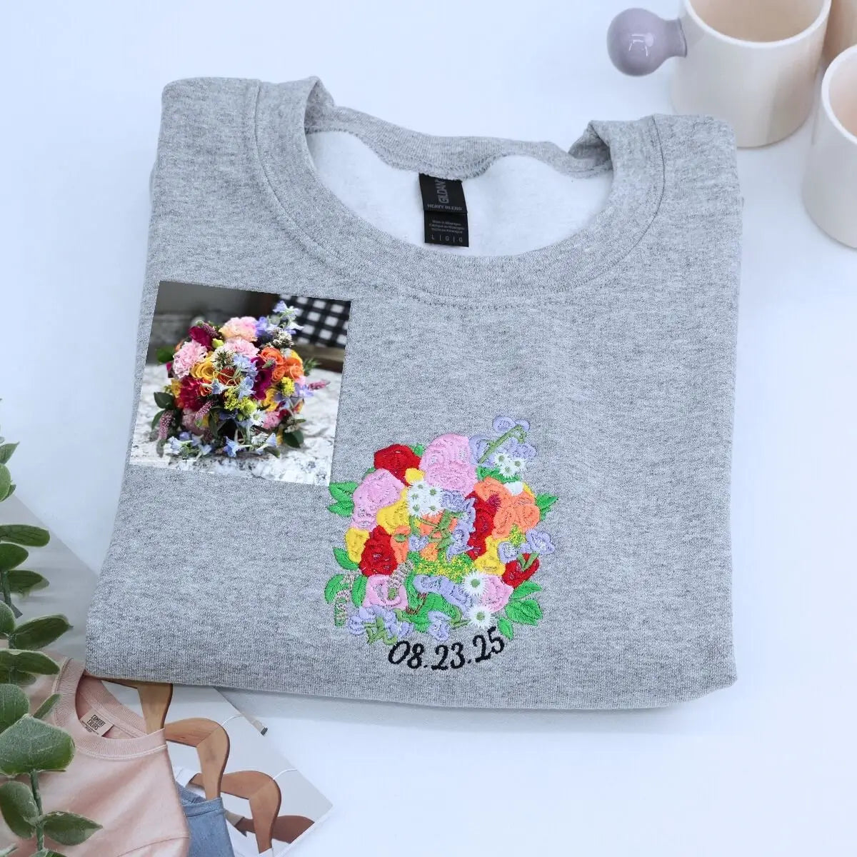 Custom embroidered sweatshirt with wedding bouquet design, personalized with name and date on sleeve
