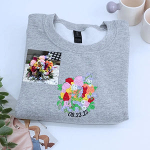 Custom embroidered sweatshirt with wedding bouquet design, personalized with name and date on sleeve
