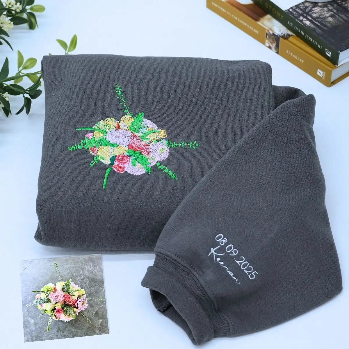 Custom embroidered sweatshirt with wedding bouquet design, personalized with name and date on sleeve