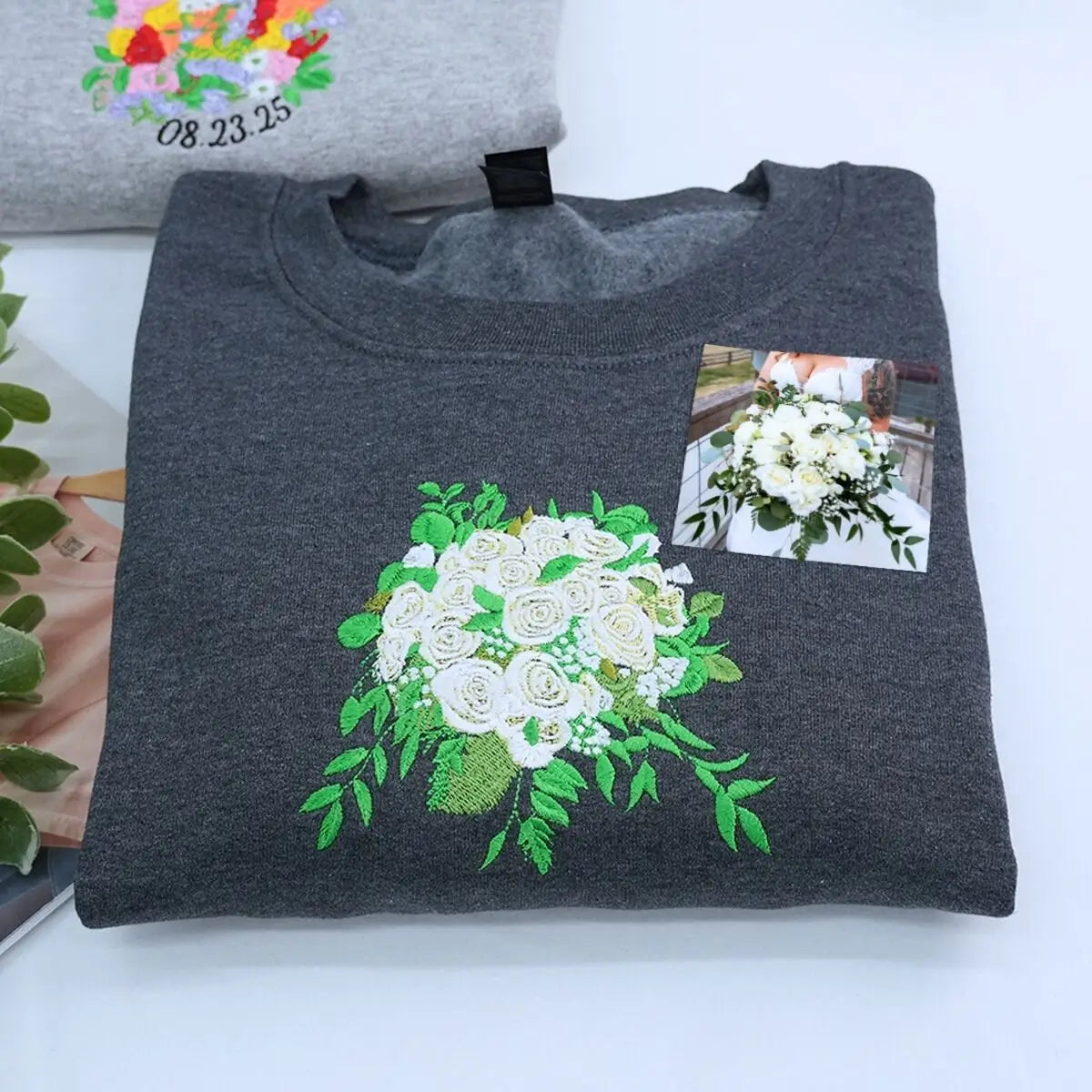 Custom embroidered sweatshirt with wedding bouquet design, personalized with name and date on sleeve