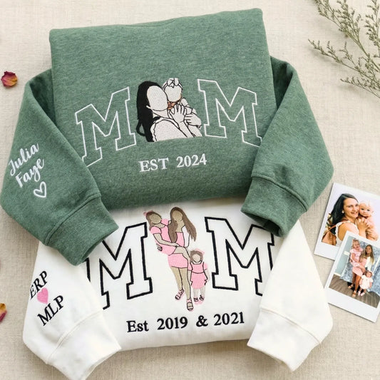 Green and white MOM sweatshirts with embroidered mother-child portrait, kids' names and est. year on sleeve