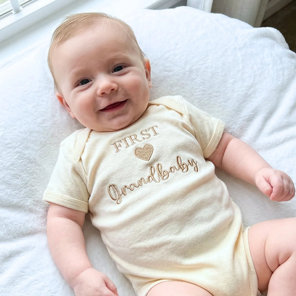 Soft embroidered newborn onesie announcing first grandbaby – perfect first-time grandparents gift