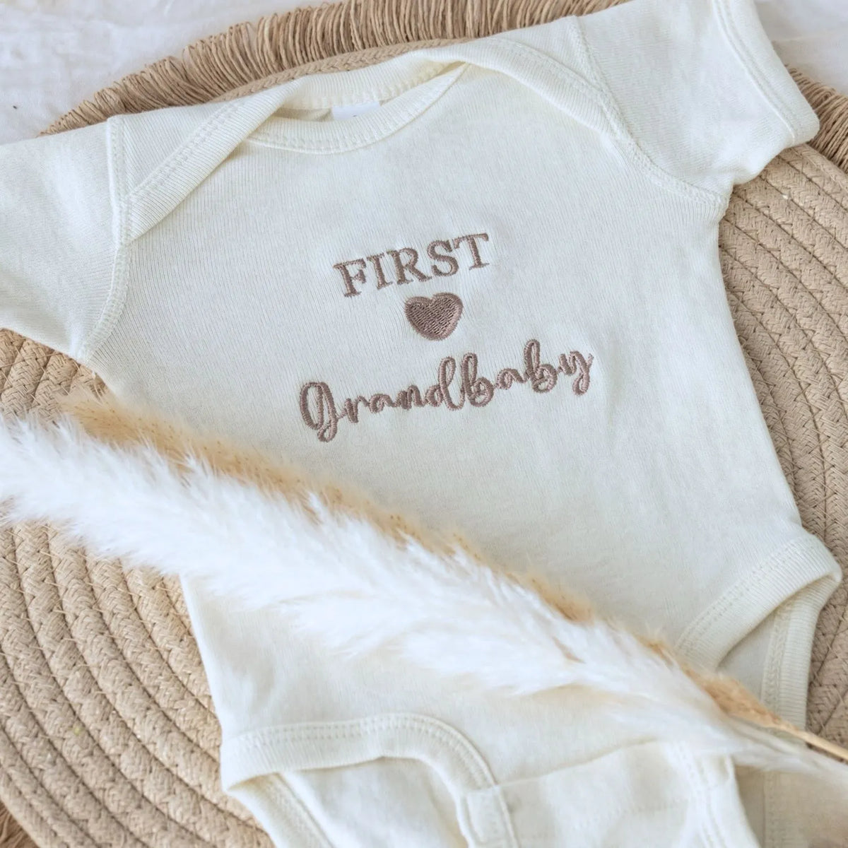 Soft embroidered newborn onesie announcing first grandbaby – perfect first-time grandparents gift