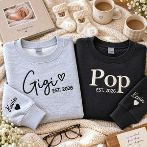 Matching sport gray Gigi and charcoal Pop embroidered sweatshirts with personalized grandchild name Kevin on sleeves, perfect for first-time grandparents gifts, pregnancy announcements, baby reveals, Christmas, and Grandparents Day.