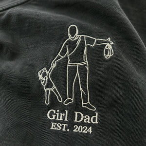 Black shirt with white embroidered design of a man and child, and text 'Girl Dad EST. 2024'.