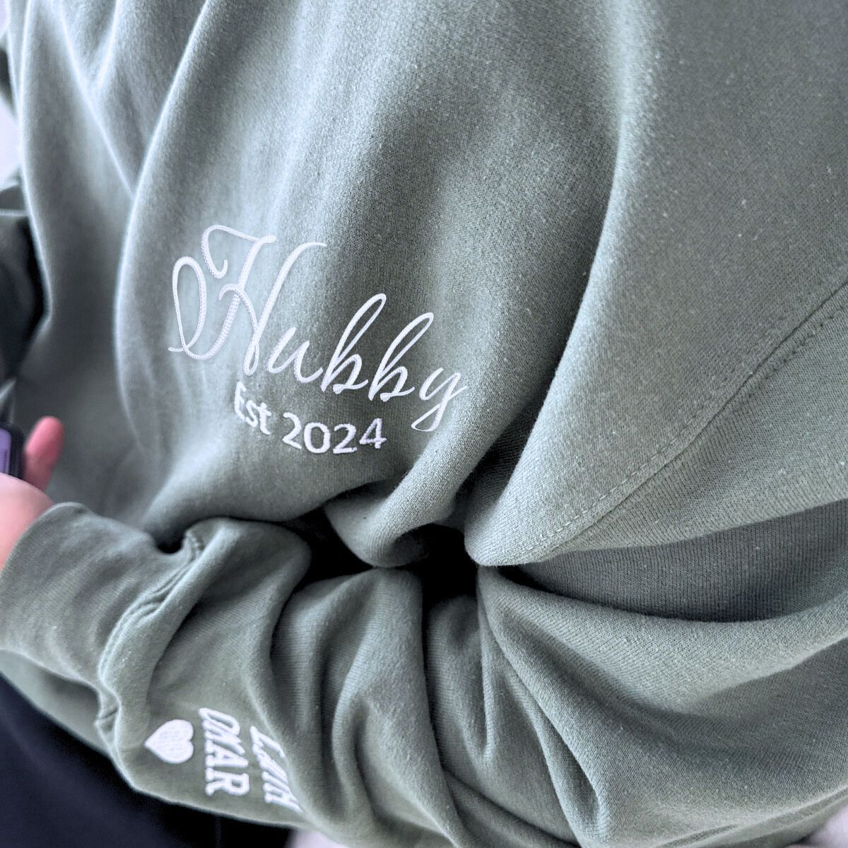 Olive green 'Hubby EST. 2024' sweatshirt with elegant embroidery, a cozy and custom anniversary or wedding gift for husbands.