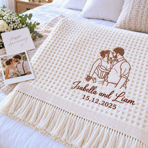 Cream waffle blanket with brown line art embroidery of a kissing couple, personalized names and wedding date.
