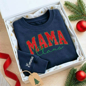 Navy Mama Claus sweatshirt with red glitter embroidery and personalized Emma sleeve, displayed in a gift box.