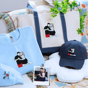 Couple wearing matching embroidered sweatshirts with hat and tote bag – romantic gift set