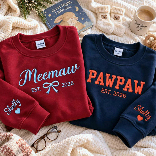 Matching maroon Meemaw and navy Pawpaw embroidered sweatshirts with personalized grandchild names on sleeves, perfect for first-time grandparents gifts, pregnancy announcements, baby reveals, and Christmas gifts.