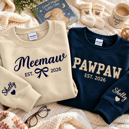 Matching maroon Meemaw and navy Pawpaw embroidered sweatshirts with personalized grandchild names on sleeves, perfect for first-time grandparents gifts, pregnancy announcements, baby reveals, and Christmas gifts.