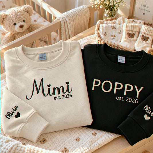 Matching white Mimi and black Poppy embroidered sweatshirts with personalized grandchild name Olivia on sleeves, perfect for first-time grandparents gifts, pregnancy announcements, baby reveals, Christmas, and Grandparents Day.