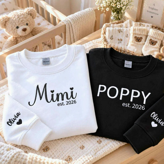 Matching white Mimi and black Poppy embroidered sweatshirts with personalized grandchild name Olivia on sleeves, perfect for first-time grandparents gifts, pregnancy announcements, baby reveals, Christmas, and Grandparents Day.